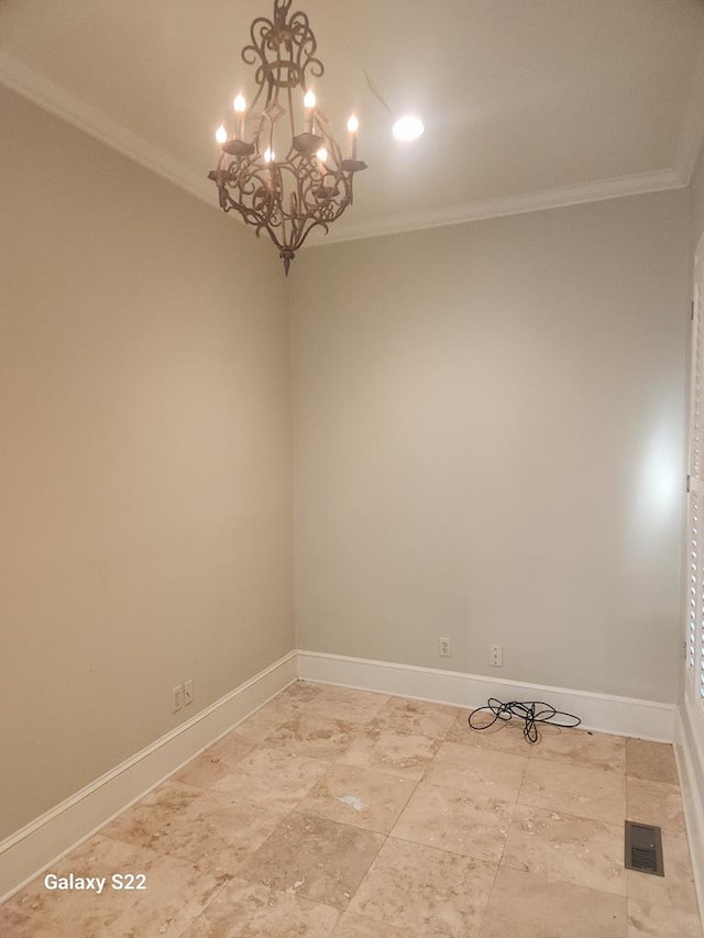 unfurnished room with crown molding and a chandelier