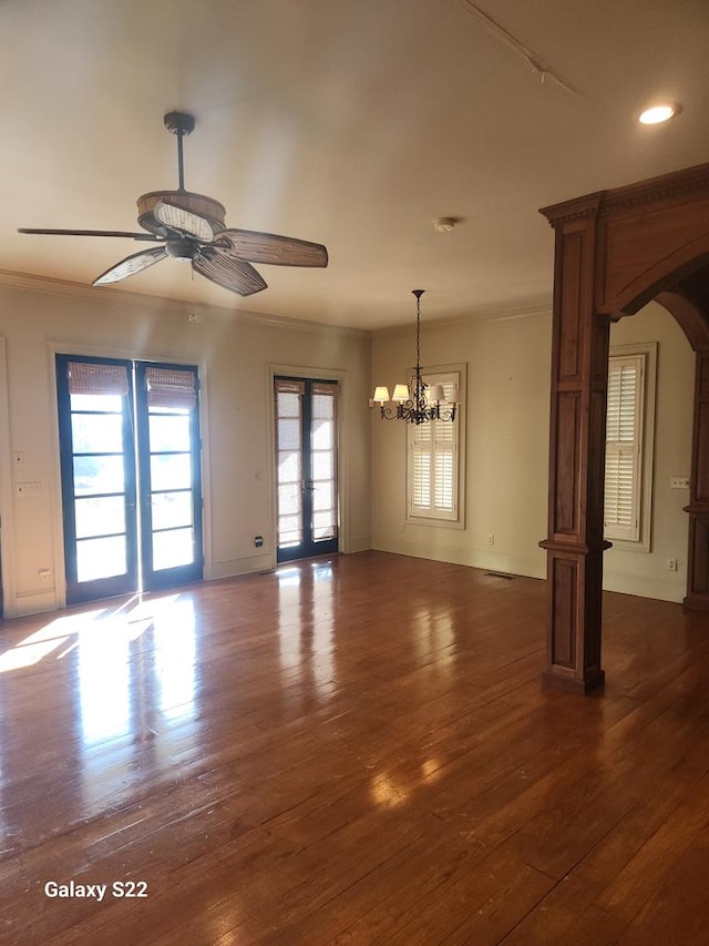 empty room featuring crown molding, plenty of natural light, and french doors