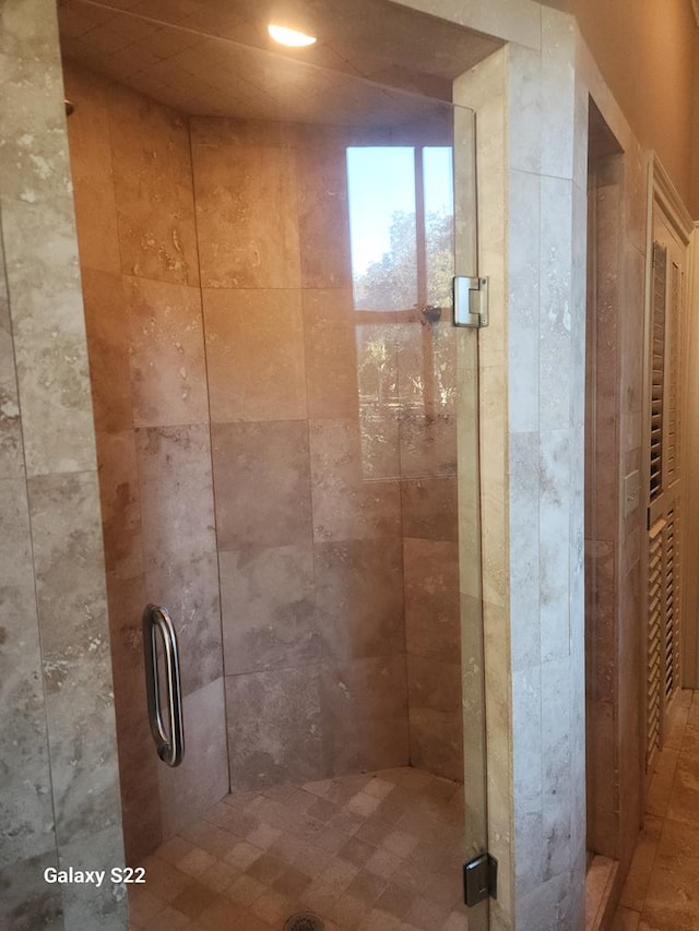 bathroom with a shower with shower door