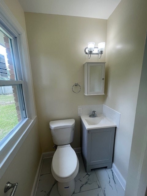 510 E 25th Ave, Cordele, GA 31015 - half bathroom featuring plenty of natural light, toilet, marble finish floors, and baseboards