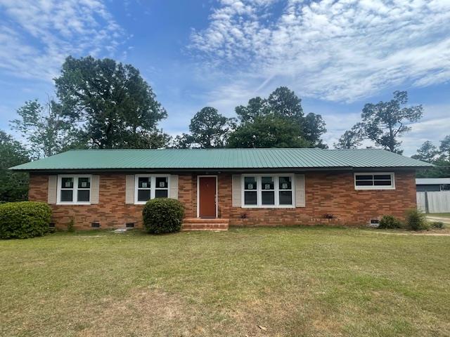510 E 25th Ave, Cordele, GA 31015 - single story home with crawl space, a front lawn, brick siding, and metal roof