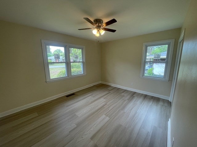 510 E 25th Ave, Cordele, GA 31015 - spare room with healthy amount of natural light, wood finished floors, ceiling fan, and baseboards