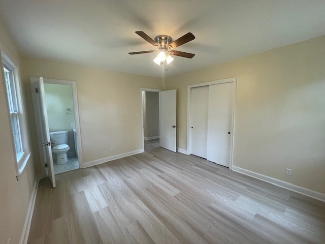510 E 25th Ave, Cordele, GA 31015 - unfurnished bedroom with light wood-type flooring, a closet, baseboards, ensuite bathroom, and a ceiling fan