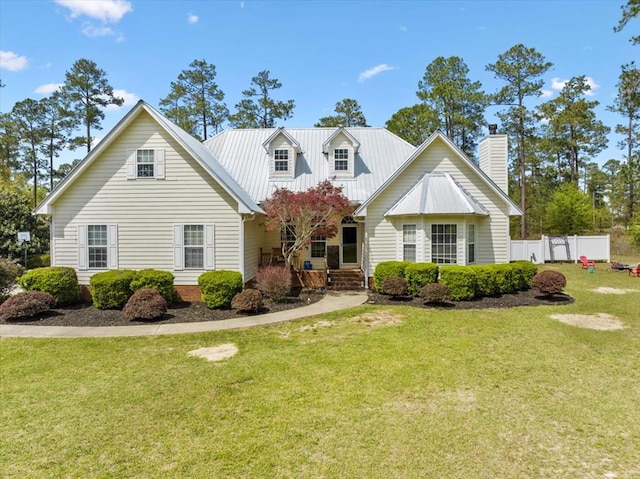 cape cod-style house featuring a front yard