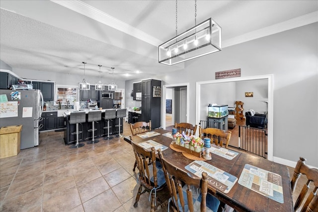 dining area featuring a textured ceiling, light tile patterned floors, and crown molding