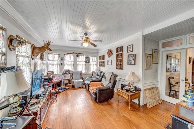 interior space featuring ceiling fan, light hardwood / wood-style flooring, and wooden ceiling