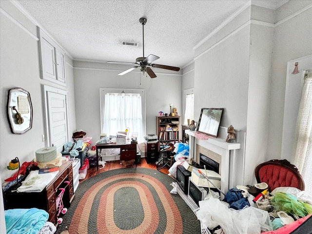 interior space with crown molding, hardwood / wood-style floors, a textured ceiling, and ceiling fan