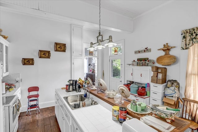 kitchen with sink, white range with electric cooktop, white cabinets, and tile countertops