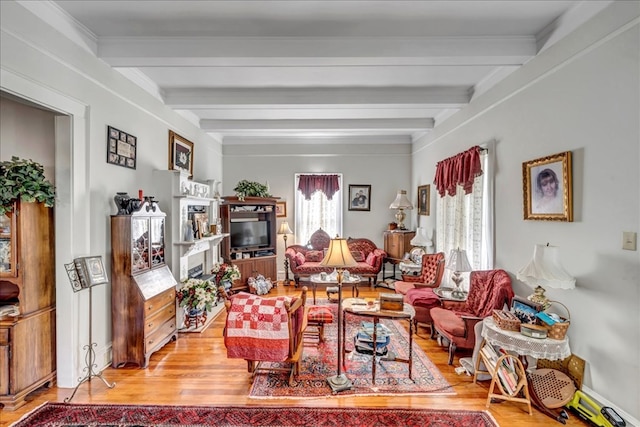 living room with beam ceiling and light wood-type flooring