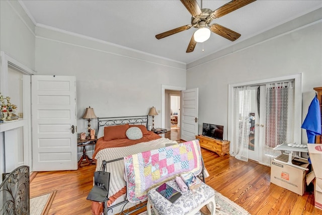 bedroom with light hardwood / wood-style floors, ceiling fan, and ornamental molding