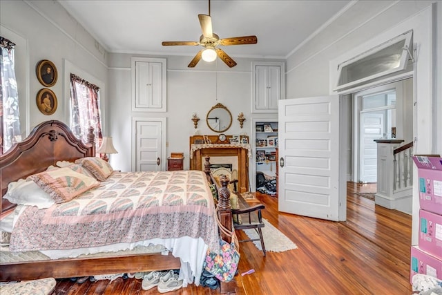 bedroom featuring ceiling fan, hardwood / wood-style flooring, and ornamental molding