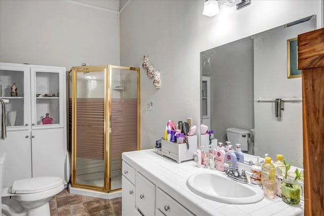 bathroom featuring toilet, walk in shower, and vanity