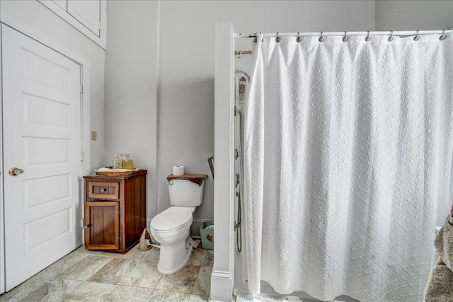 bathroom with toilet and a shower with shower curtain