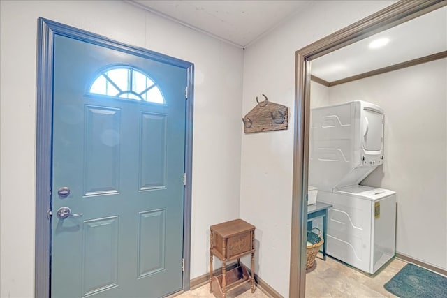 foyer entrance featuring stacked washer and dryer