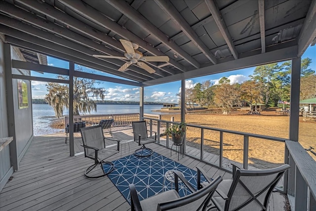 wooden deck with a water view and ceiling fan