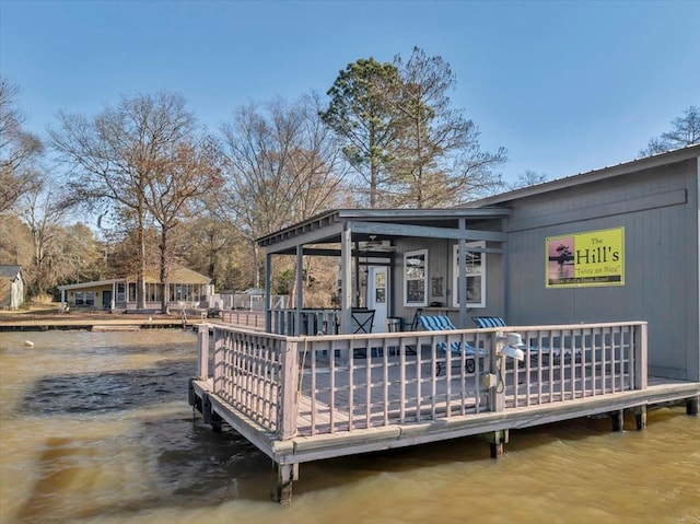 exterior space with a deck with water view