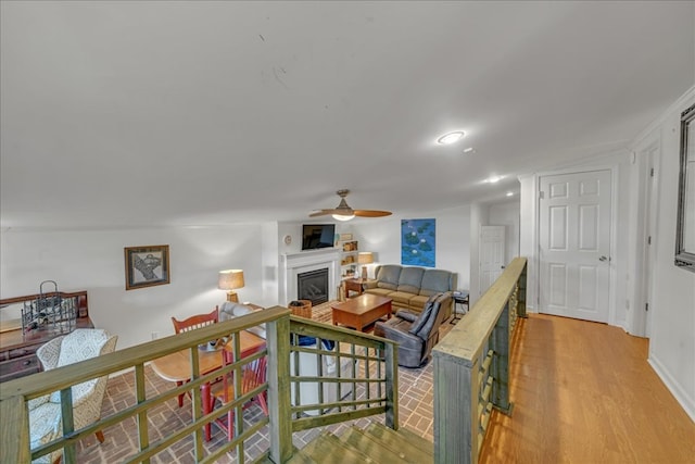 living room with ceiling fan and hardwood / wood-style floors