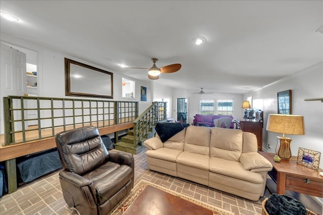 living room featuring ceiling fan, crown molding, and vaulted ceiling