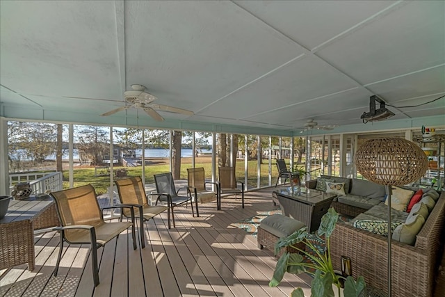 deck featuring ceiling fan and outdoor lounge area