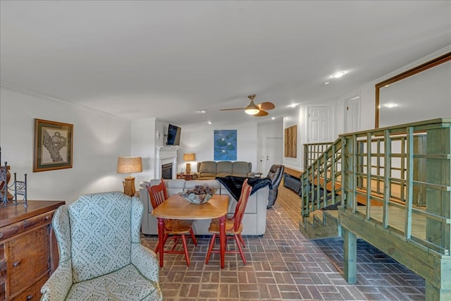 dining area featuring ceiling fan and ornamental molding