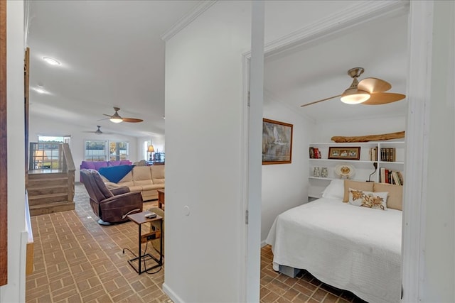 bedroom with vaulted ceiling, ceiling fan, and crown molding