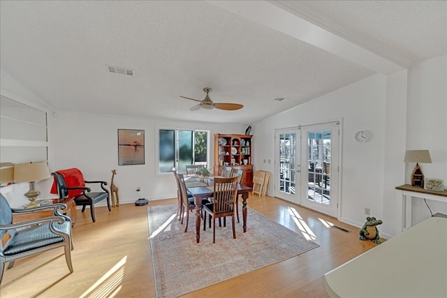 dining room with vaulted ceiling, french doors, and a healthy amount of sunlight