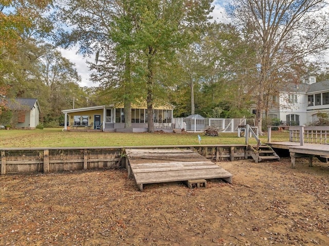 view of yard featuring a sunroom and a shed