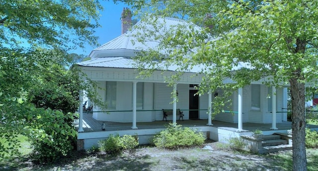 back of house featuring a porch