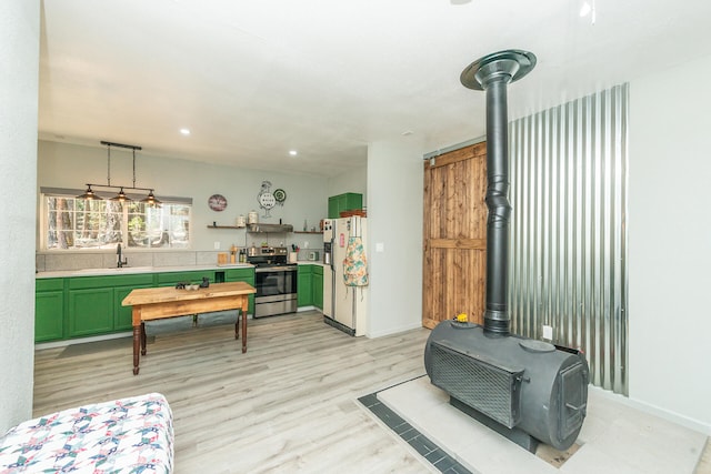 interior space featuring a wood stove, light hardwood / wood-style flooring, and sink