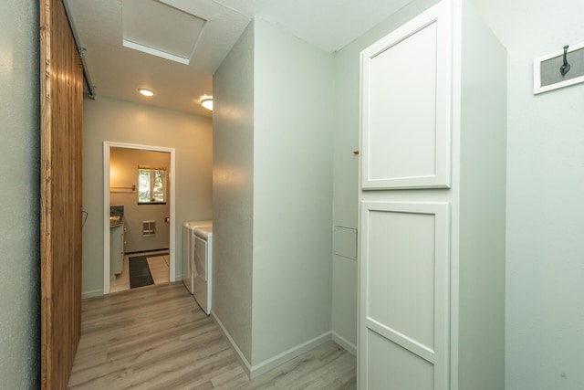 corridor featuring independent washer and dryer and light wood-type flooring