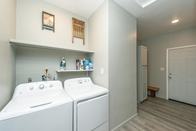 laundry area with washer hookup, light hardwood / wood-style flooring, and washing machine and clothes dryer