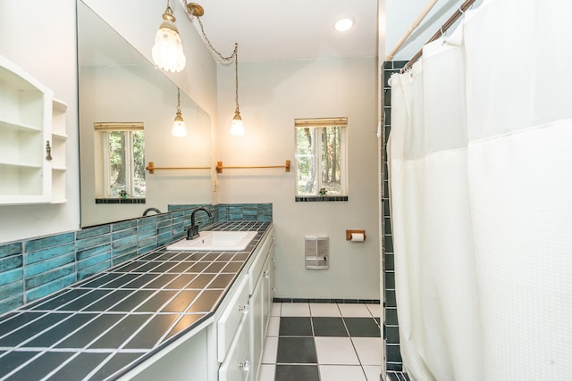 bathroom featuring backsplash, tile floors, and vanity