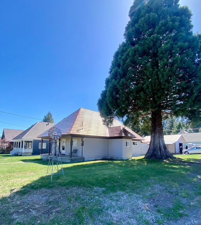 view of side of property with a yard