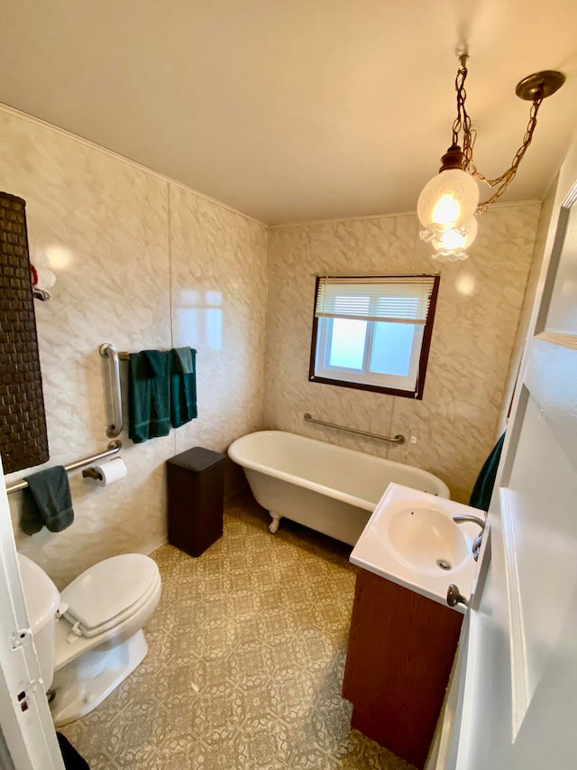 bathroom featuring a bathtub, toilet, vanity, tile walls, and tile patterned floors