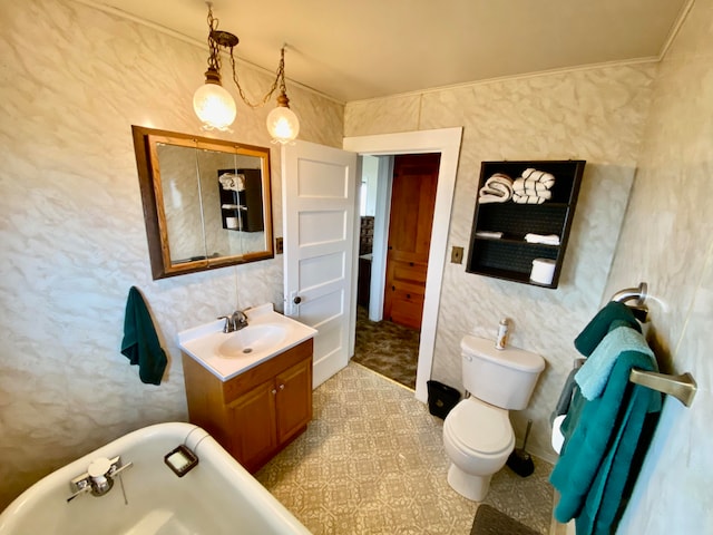 bathroom with tile patterned flooring, a tub, toilet, and vanity