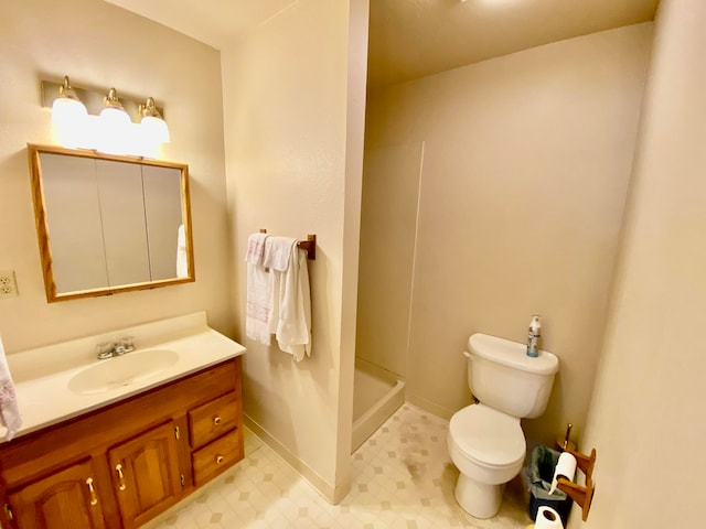 bathroom with tile patterned floors, vanity, walk in shower, and toilet