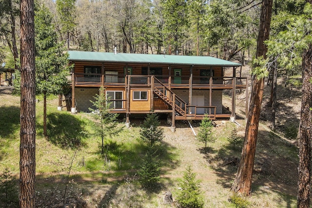 back of house with a wooden deck