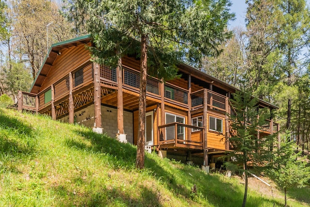 back of property featuring a deck