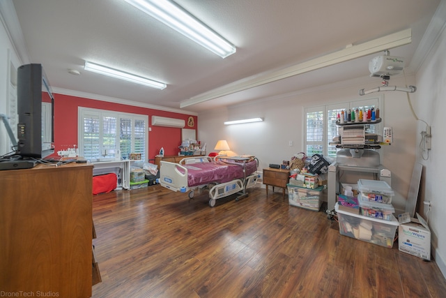 bedroom featuring multiple windows, crown molding, dark hardwood / wood-style floors, and a wall mounted air conditioner