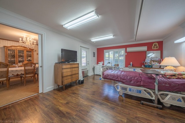 bedroom with an inviting chandelier, an AC wall unit, and dark hardwood / wood-style floors