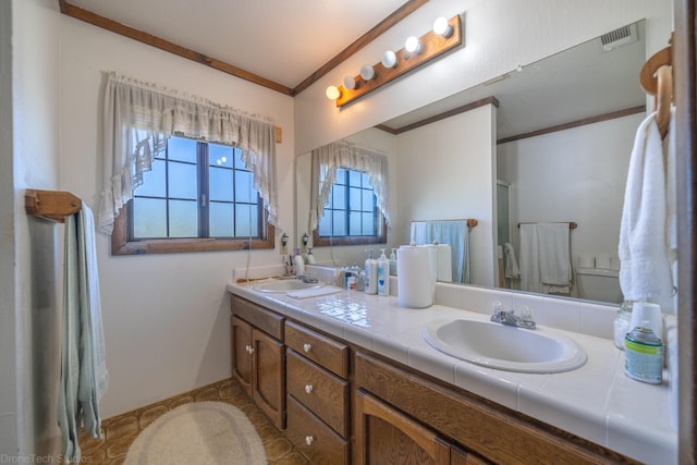 bathroom featuring ornamental molding, tile flooring, and dual vanity