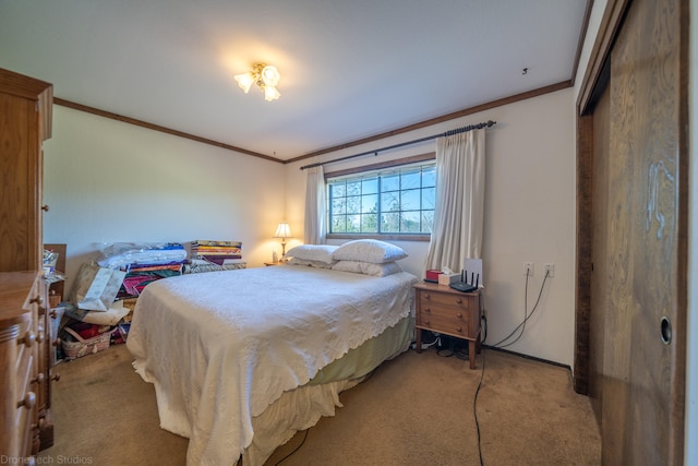 carpeted bedroom with ornamental molding