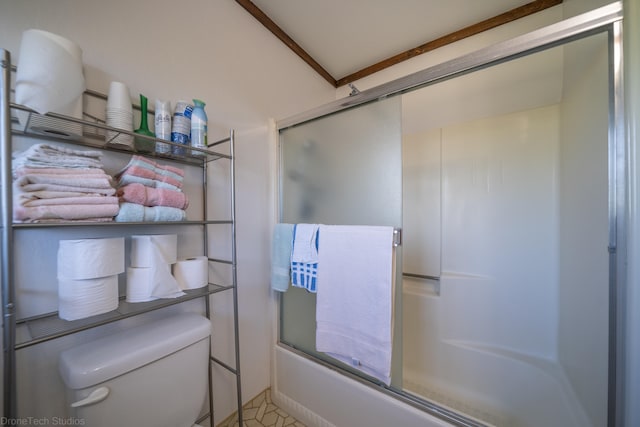 bathroom with toilet and bath / shower combo with glass door