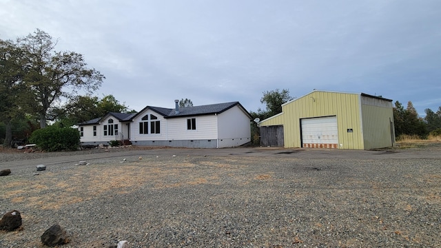 view of front of property with an outbuilding and a garage