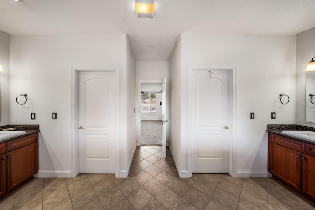 bathroom with tile flooring and vanity with extensive cabinet space