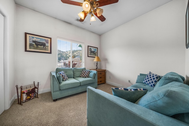 carpeted living room with ceiling fan and lofted ceiling