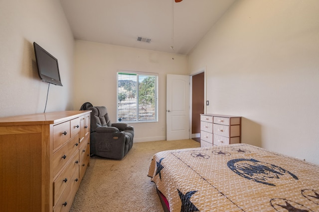 bedroom with vaulted ceiling and light colored carpet