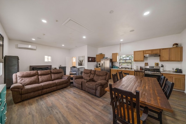 living room with a wall mounted air conditioner and dark wood-type flooring