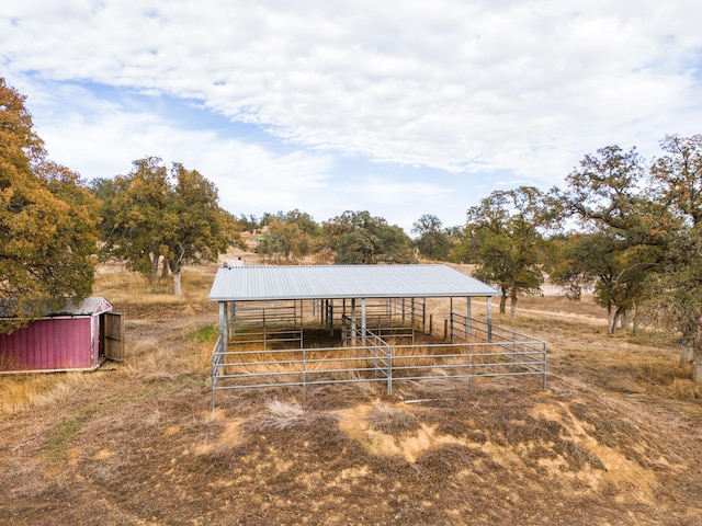 view of yard with a rural view and an outdoor structure