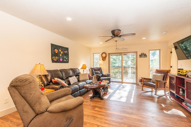 living room with ceiling fan and light hardwood / wood-style flooring